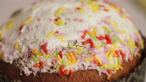 Easter cake topped with sugar icing and decorated with colorful sprinkles Stock Footage 335712729