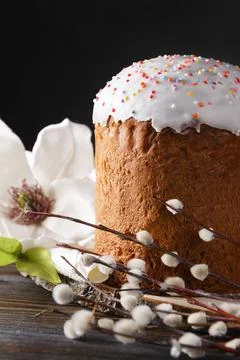Easter cake with willow twigs and a white magnolia flower on a dark backgroun Foto stock
