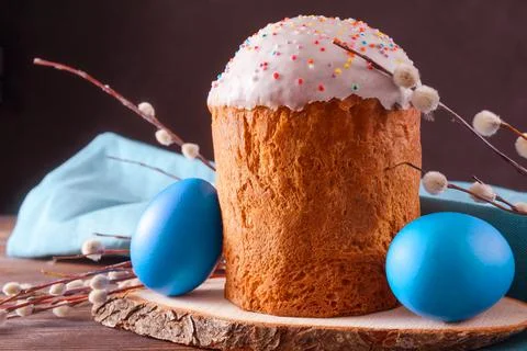Easter cake with willow twigs and blue painted eggs on a dark background Stock Photos
