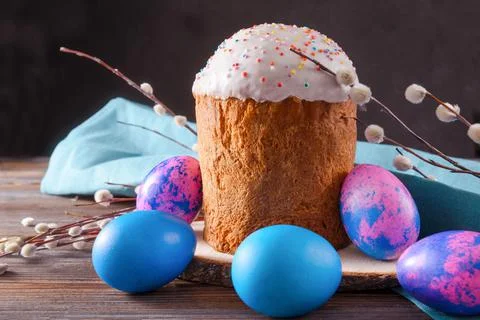 Easter cake with willow twigs and blue , lilac eggs on a dark background Stock Photos