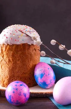 Easter cake with willow twigs and pink, lilac  eggs on a dark Stock Photos