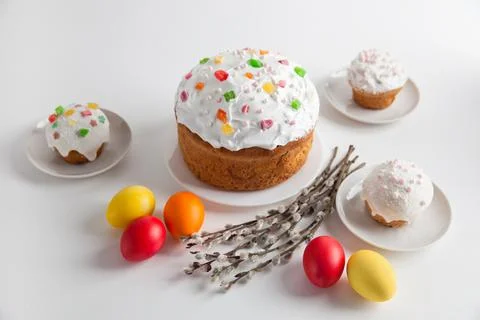 Easter cakes and colorful Easter eggs with willow branches on a white backgro Stock Photos