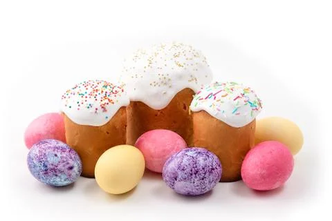 Easter cakes and Easter colored eggs on an isolated white background. Stock Photos