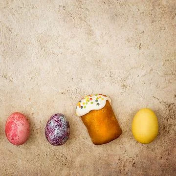 Easter cakes and Easter colored eggs on a beautiful textured background. Stock Photos
