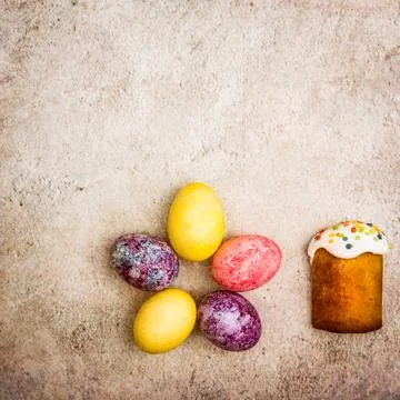 Easter cakes and Easter colored eggs on a beautiful textured background. Stock Photos