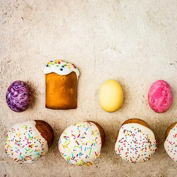 Easter cakes and Easter colored eggs on a beautiful textured background. Stock Photos