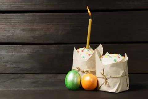 Easter cakes with colored colored eggs on a dark background. Stock Photos