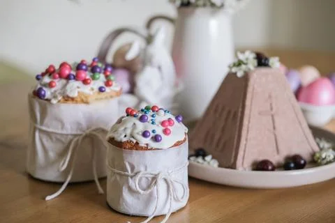 Easter cakes with colored sprinkles, multi-colored painted eggs, chocolate .. Stock Photos