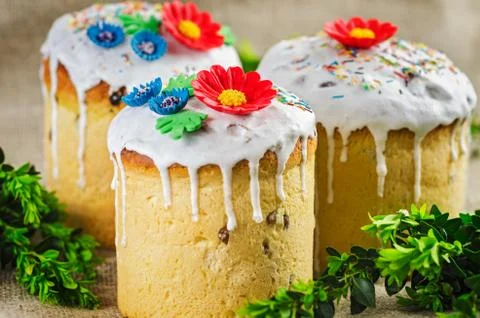 Easter cakes with flowers on rustic background Stock Photos