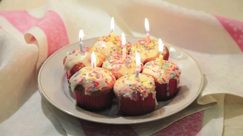 Easter cakes with white icing and blowing out candles. Homemade baking. Stock Footage 73507176