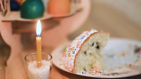Easter candle burns on the table next to Easter cake Stock Footage 111285131