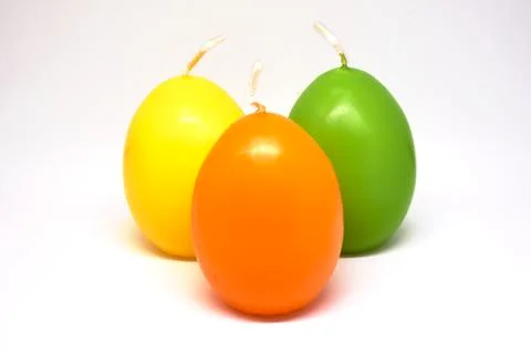 Easter candle in egg form on a white background Stock Photos