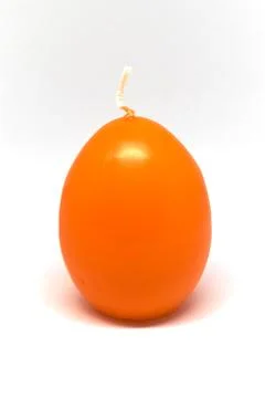 Easter candle in egg form on a white background Stock Photos