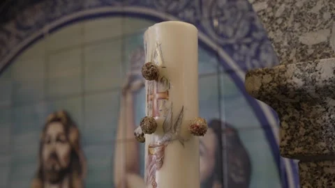 Easter candle in front of religious tile panel Stock Footage 306832325