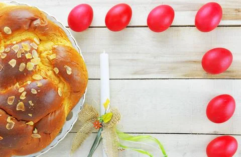 Easter candle,Easter red eggs and Easter bread Stock Photos