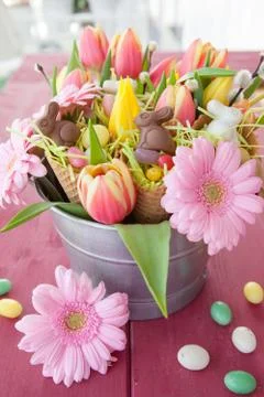Easter candy and spring flowers Stock Photos