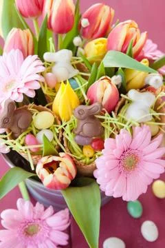 Easter candy and spring flowers Stock Photos
