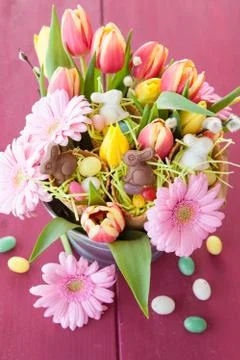 Easter candy and spring flowers Stock Photos
