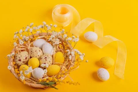 Easter candy chocolate eggs and almond sweets lying in a bird's nest Stock Photos