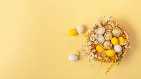 Easter candy chocolate eggs and almond sweets lying in a bird's nest Stock Photos