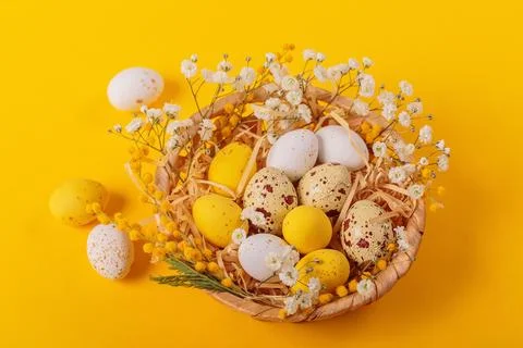 Easter candy chocolate eggs and almond sweets lying in a bird's nest Stock Photos