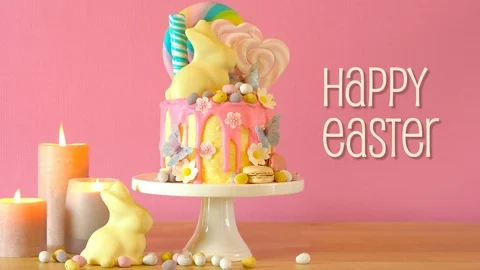 Easter candyland drip cake with white chocolate bunny in party table setting. Stock Footage 104721911