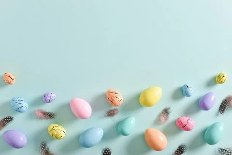 Easter card with bed-colored eggs and feathers Stock Photos