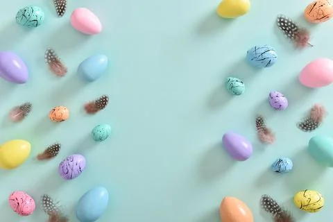 Easter card with bed-colored eggs and feathers with a copy of the place for t Stock Photos