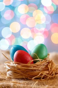 Easter card, colored eggs in the nest. Toy Bicycle with a cart. happy Easter. Stock Photos