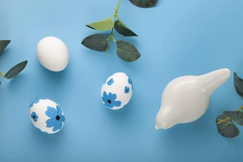 Easter card design. Easter eggs decorated flowers on blue background. Stock Photos