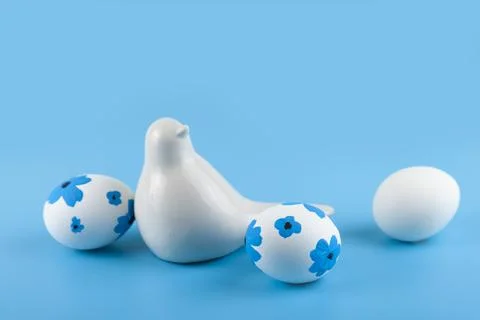 Easter card design. Easter eggs decorated flowers on blue background. Stock Photos