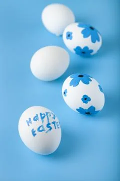 Easter card design. Easter eggs decorated flowers on blue background. Stock Photos