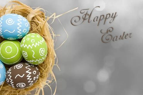 Easter card. Painted Easter eggs in nest on gray background Foto stock