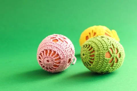 Easter cards: three Easter eggs decorated with a handmade knitted pattern on  Stock Photos