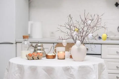 Easter celebration concept. Easter eggs, bottle of milk, branches with colorful Foto stock