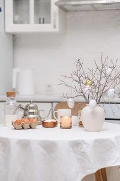 Easter celebration concept. Easter eggs, bottle of milk, branches with colorful Stock Photos