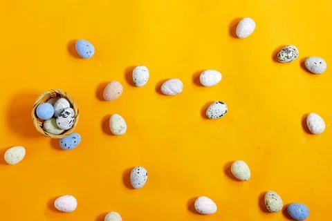 Easter celebration concept featuring painted decorative eggs on a bright orange  Stock Photos