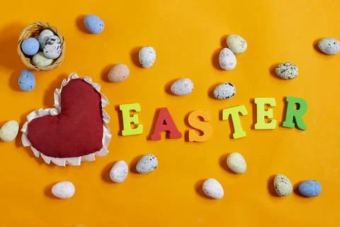 Easter celebration concept featuring painted decorative eggs, themed letters spe Stock Photos