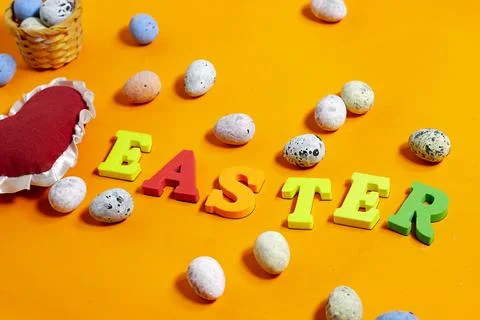 Easter celebration concept featuring painted decorative eggs, themed letters spe Stock Photos