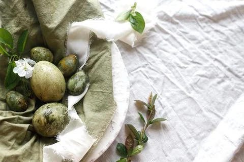 Easter celebration flat lay. Stylish easter green eggs, flowers and cherry .. Stockfoto's