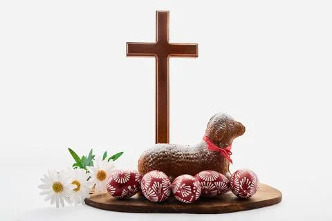Easter celebration with lamb cake, cross, and painted eggs Stock Photos