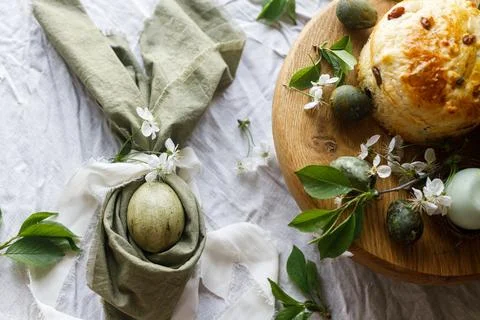 Easter celebration. Stylish green easter eggs in bunny ears napkin, easter .. Stock Photos