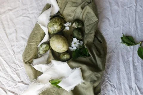 Easter celebration. Stylish green easter eggs, flowers and cherry blossoms .. Stock Photos