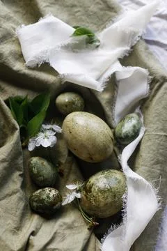 Easter celebration. Stylish green easter eggs, flowers and cherry blossoms .. Stock Photos