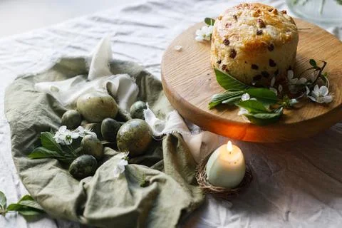 Easter celebration. Stylish green easter eggs, easter bread, candle and che.. Stock Photos