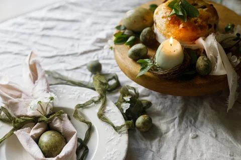 Easter celebration. Stylish green easter eggs in bunny ears napkin, easter .. Stock Photos