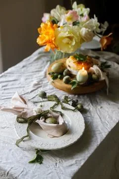 Easter celebration. Stylish green easter eggs in bunny ears napkin, easter .. Stock Photos
