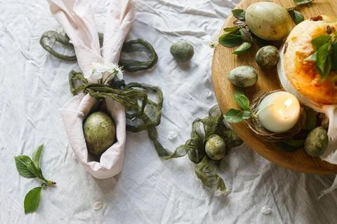 Easter celebration. Stylish green easter eggs in bunny ears napkin, easter .. Stockfoto's