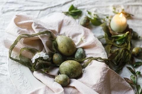 Easter celebration. Stylish green easter eggs, flowers, cherry blossoms and.. 库存照片