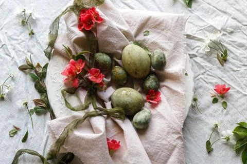 Easter celebration. Stylish green easter eggs, flowers, cherry blossoms  on.. Stockfoto's